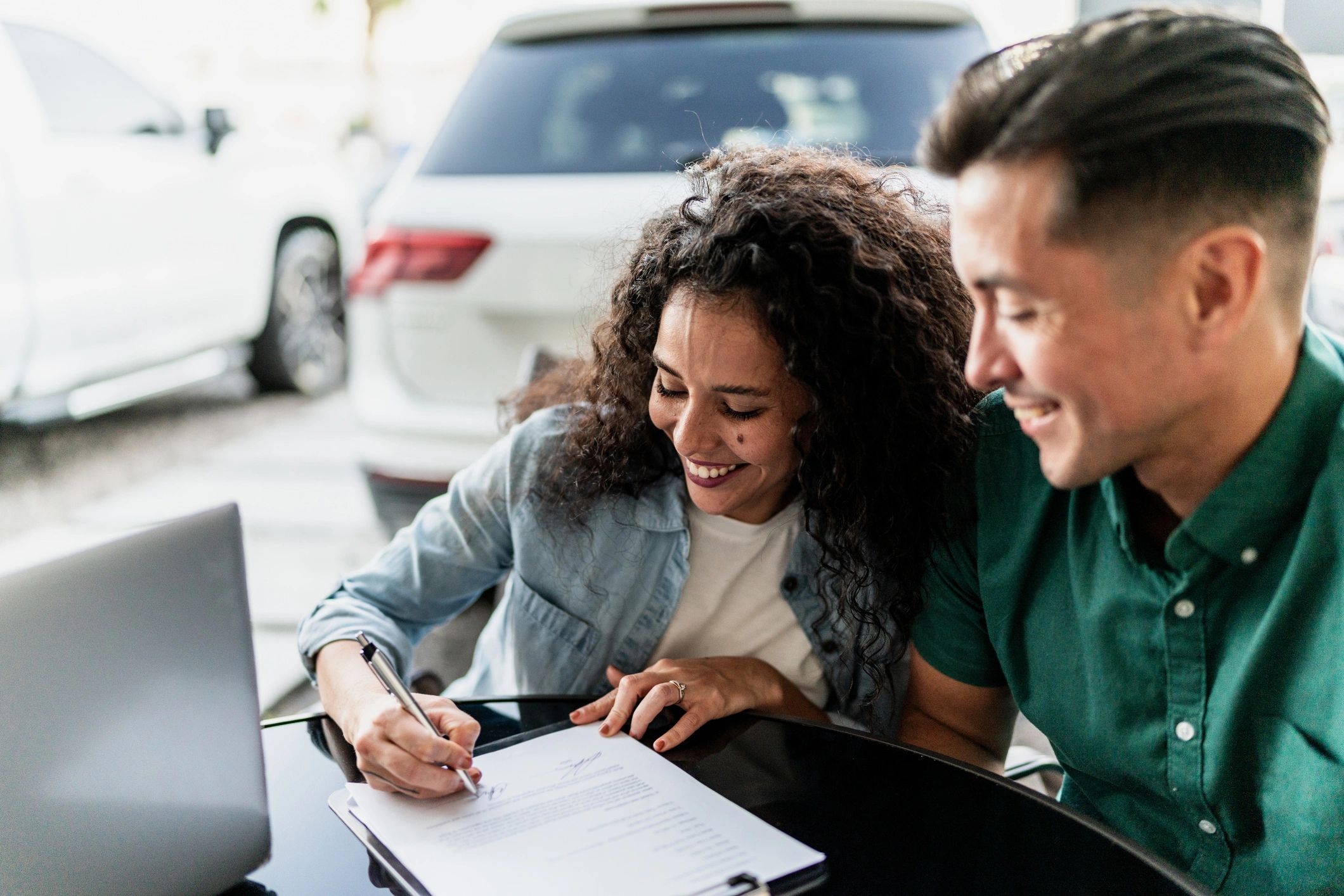 Buyer reviewing a vehicle purchase with paperwork