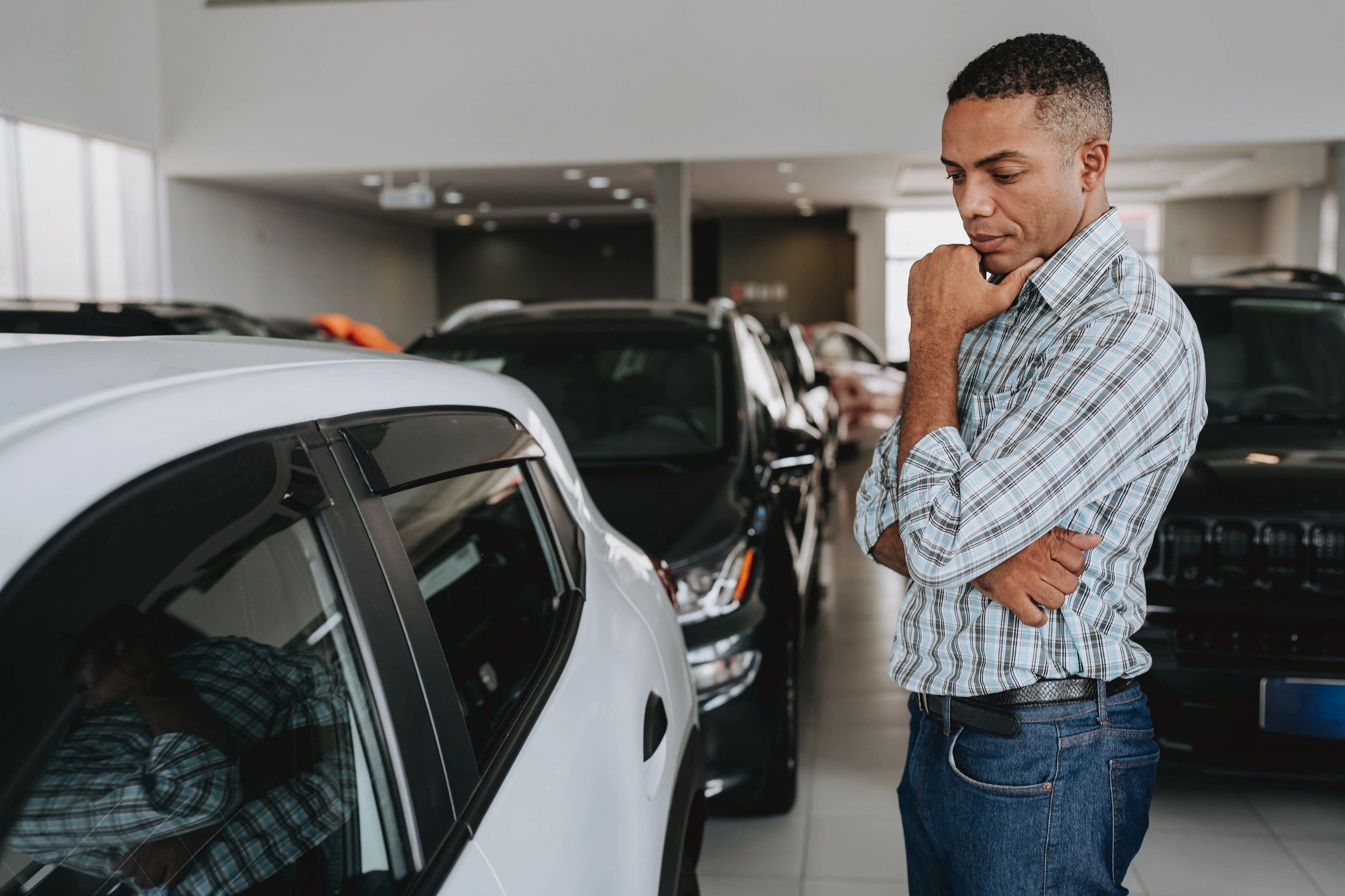 Buyer inspecting a vehicle in a lot